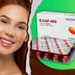 E cap 400 কি কাজ করে তা বোঝানো একটি চিত্র, যেখানে সুন্দর ত্বক ও চুলের ছবি এবং ই ক্যাপ ৪০০ ক্যাপসুল দেখা যাচ্ছে, যা এই ক্যাপসুলের ত্বক ও চুলের যত্নে ভূমিকা তুলে ধরে।